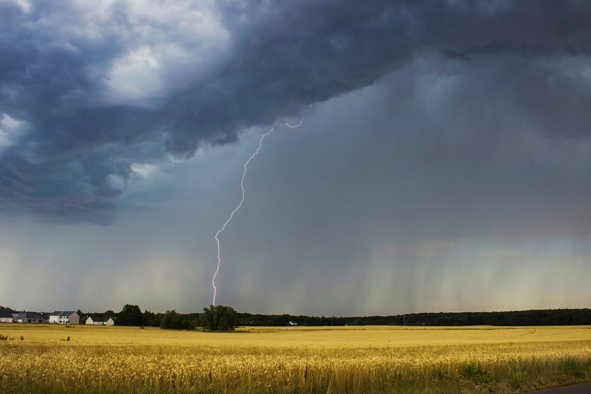 Furtună de vară cu fulgere deasupra unui peisaj rural